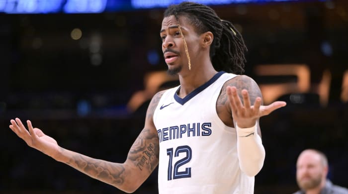 Grizzlies guard Ja Morant holds his hands up after a play against the Lakers.
